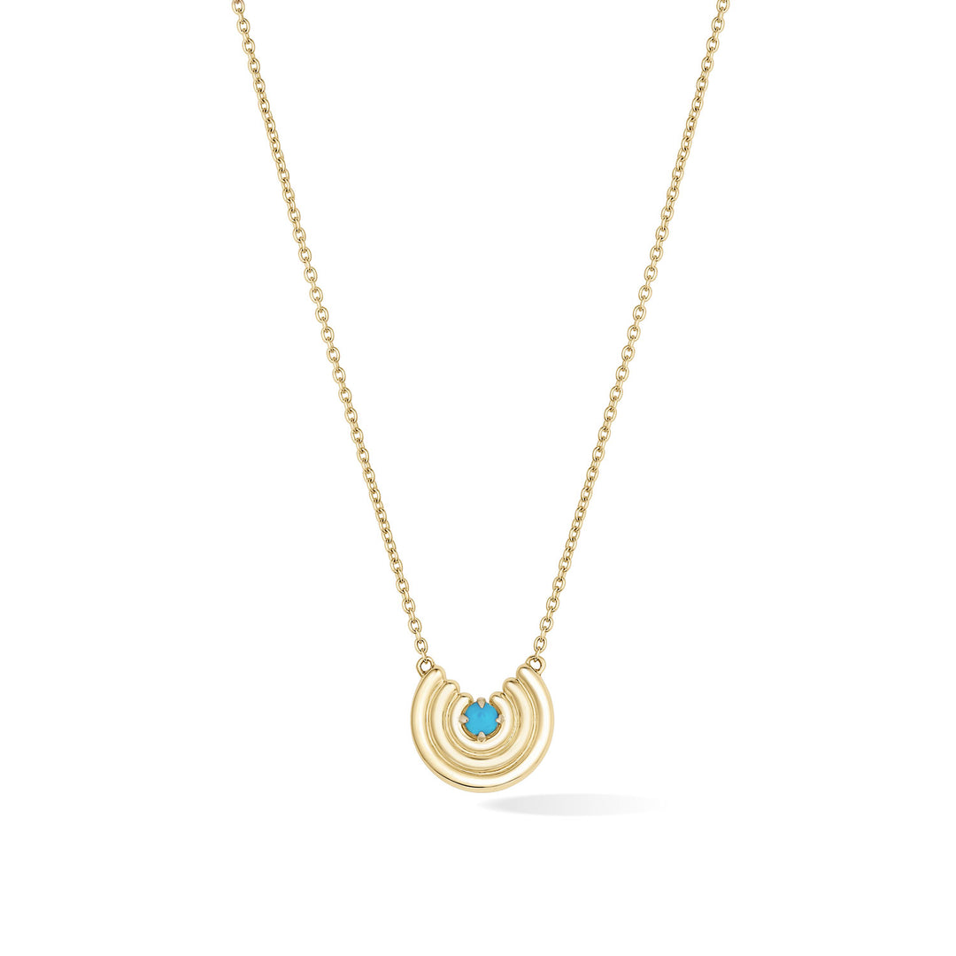 A delicate gold chain necklace featuring a crescent-shaped pendant with turquoise gemstone at the center, shown against a plain white background. December birthstone necklace gift.
