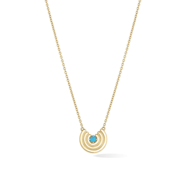 A delicate gold chain necklace featuring a crescent-shaped pendant with turquoise gemstone at the center, shown against a plain white background. December birthstone necklace gift.