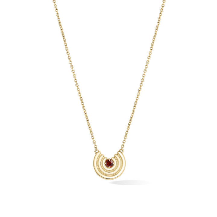 A delicate gold chain necklace featuring a crescent-shaped pendant with a dark red garnet gemstone at the center, shown against a plain white background. January birthstone necklace gift.
