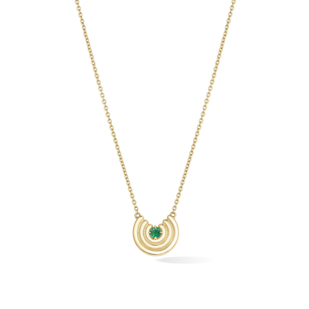 A delicate gold chain necklace featuring a crescent-shaped pendant with an emerald gemstone at the center, shown against a plain white background. May birthstone necklace gift