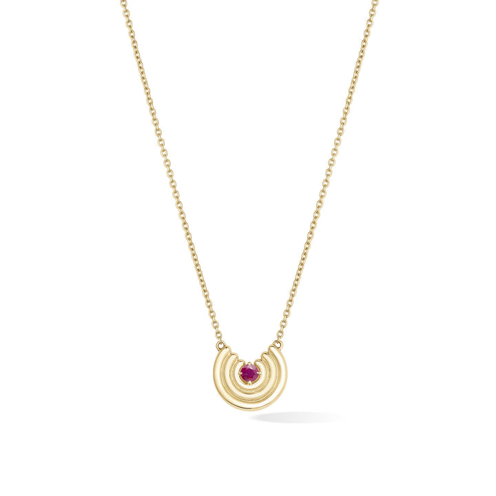 A delicate gold chain necklace featuring a crescent-shaped pendant with a red ruby gemstone at the center, shown against a plain white background. July birthstone necklace gift.