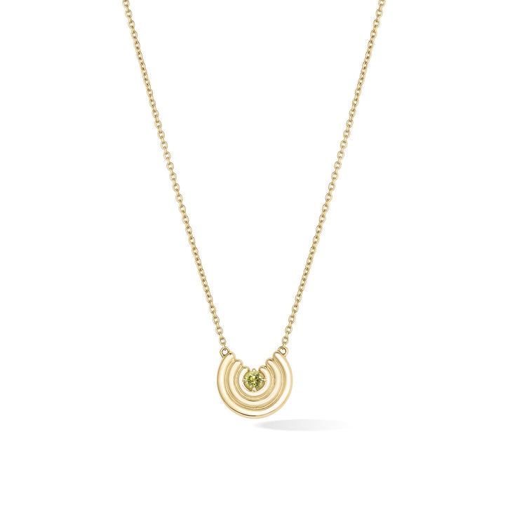 A delicate gold chain necklace featuring a crescent-shaped pendant with an light green peridot gemstone at the center, shown against a plain white background. August birthstone necklace