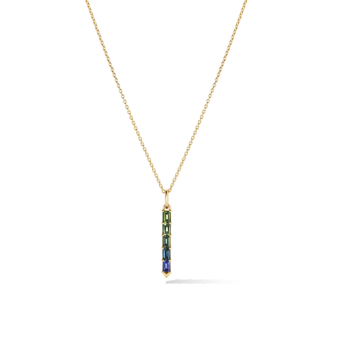 Gold chain with a green and blue ombre sapphire pendant on a white background