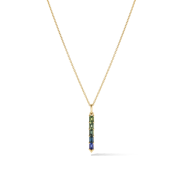 Gold chain with a green and blue ombre sapphire pendant on a white background