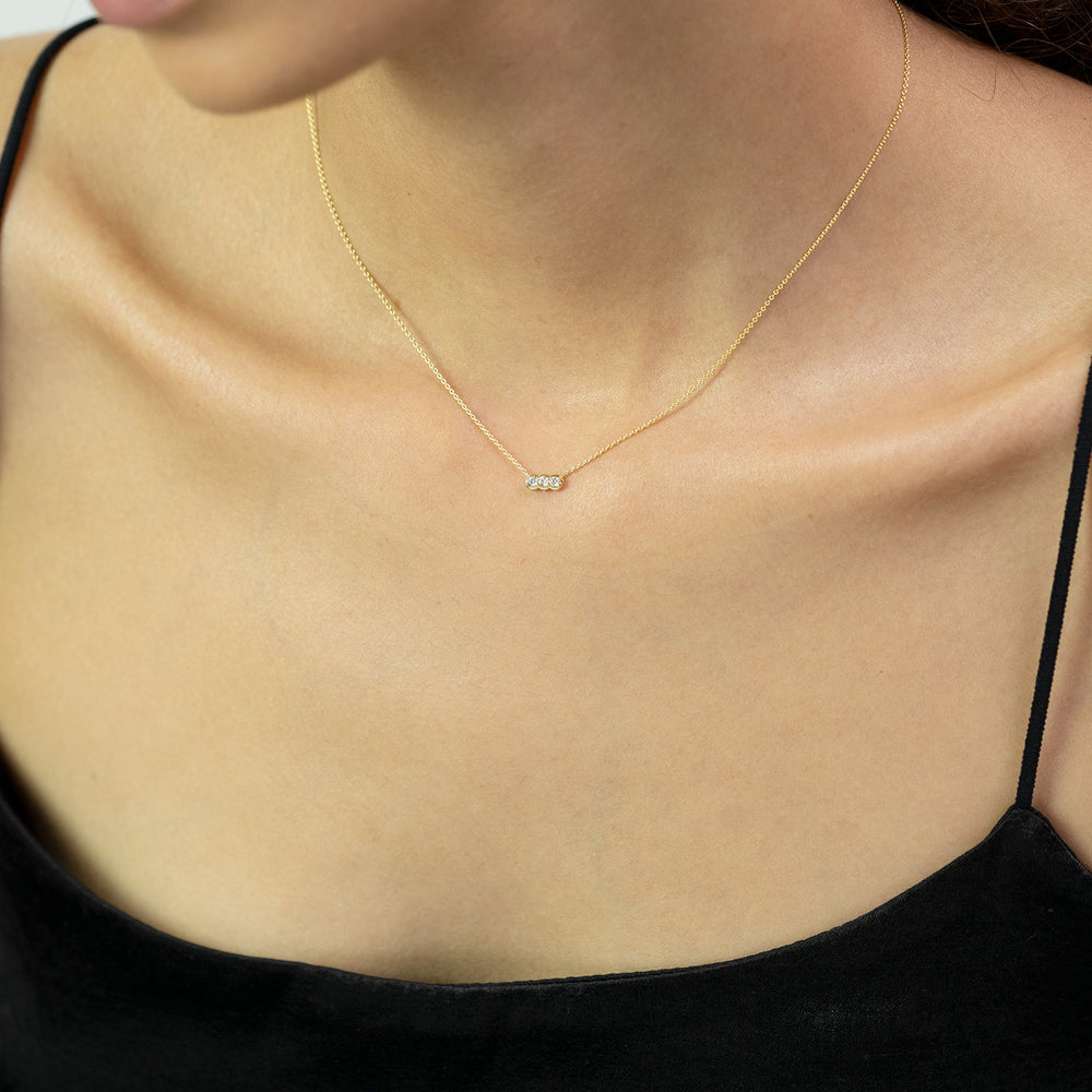 Palace Diamond Trio Necklace—three diamonds in a minimal bar on 14k gold chain on a model