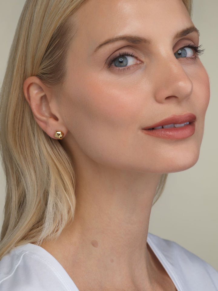 close up of a model wearing a gold vermeil geometric facet stud earring by Parkford